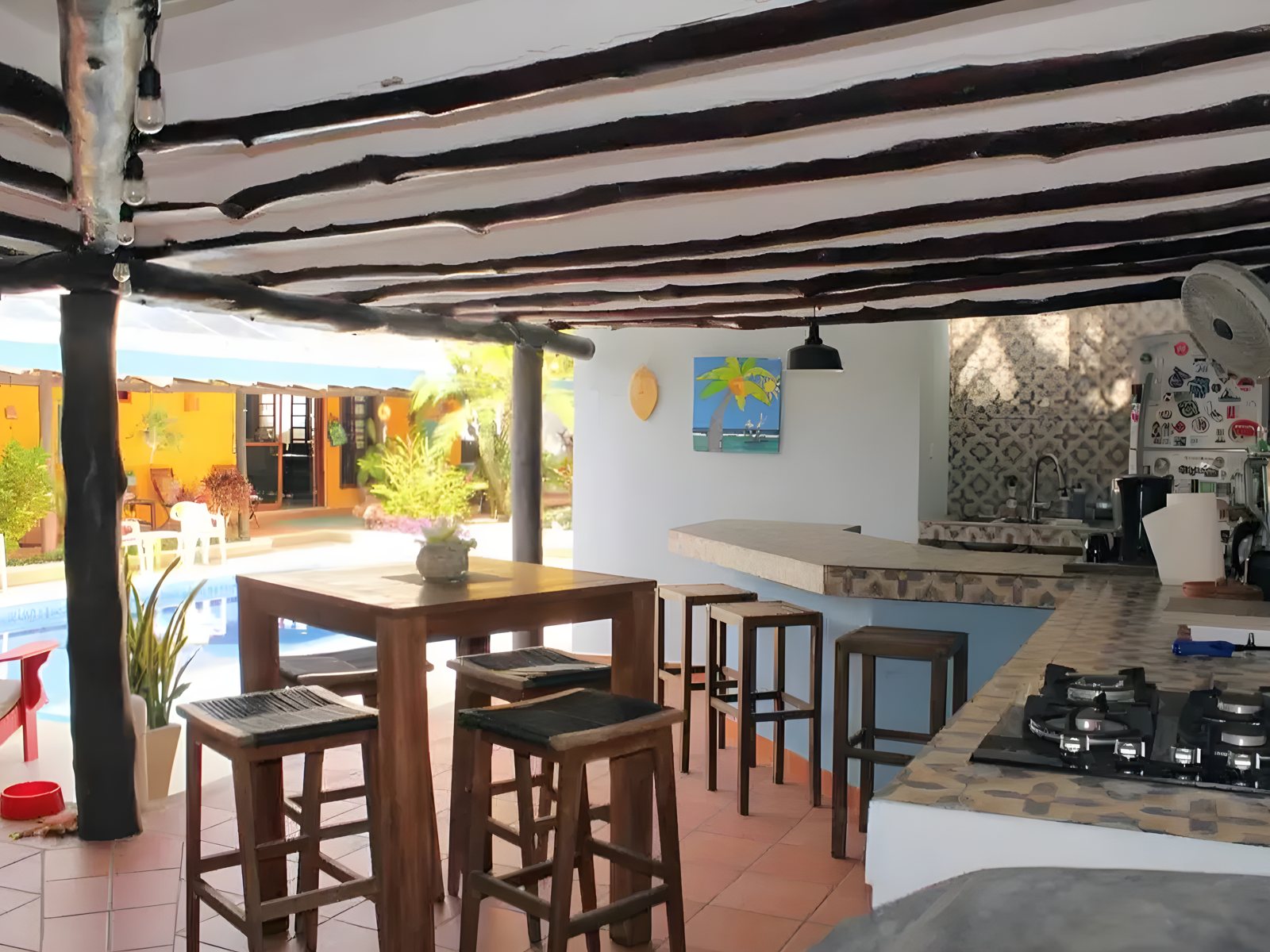 The outdoor kitchen and bar beside the pool